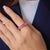 This striking contemporary eternity band showcases a continuous row of 18 emerald cut pink sapphires totaling...