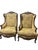 Bring timeless French elegance to your home with this exceptional pair of carved walnut bergère-style lounge chairs....