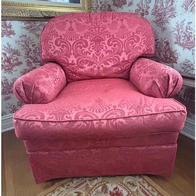 Beautifully upholstered club chair in a deep coral damask. Rolled arms with nicely pleated end detail. (arm covers...