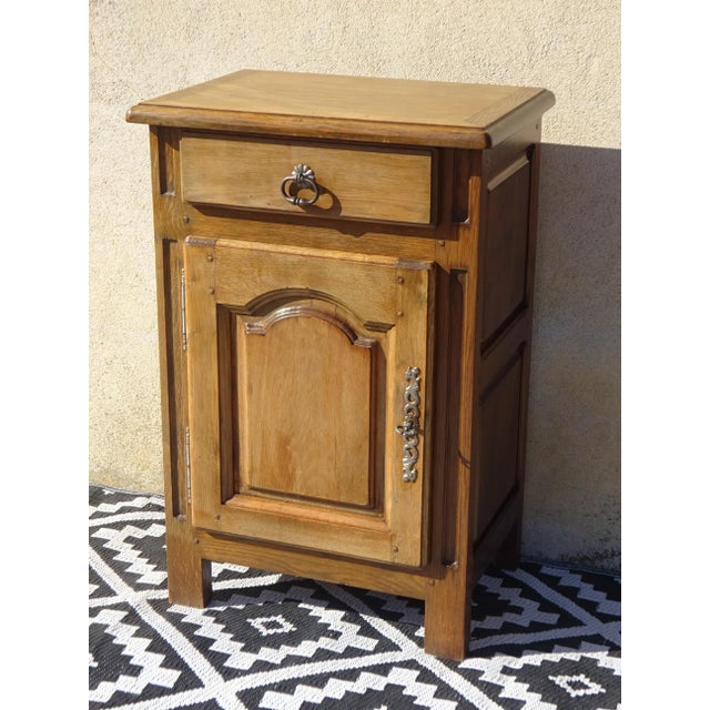 Solid oak top with rounded edges, sanded and varnished with a matte clear finish. One storage drawer with an aged metal...