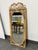 Design Plus Gallery presents a Vintage Scrollwork Rattan Wall Mirror. This mirror has a rectangular rattan frame...