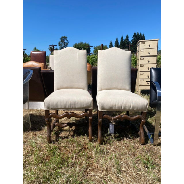 Two Louis VIII style chairs made in France in 1860 with deeply patinaed ash, upholstered in white linen.