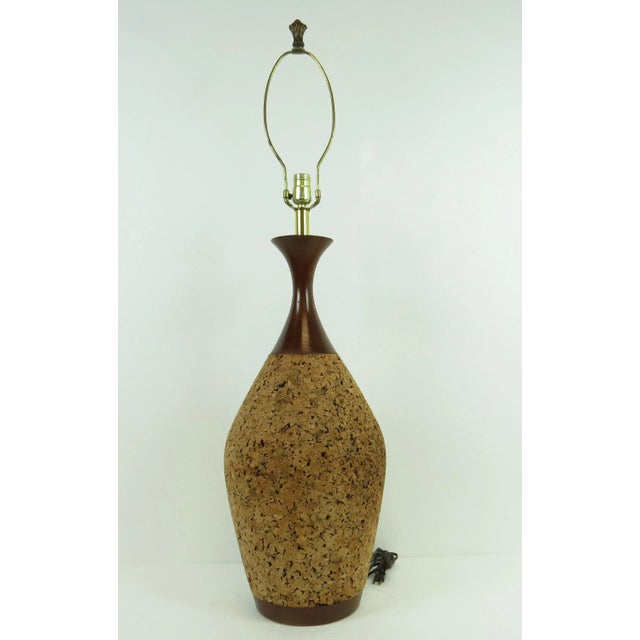 Large sized mid-century modern walnut and cork lamp of epic proportion! Includes harp, finial, and original shade. Lamp...
