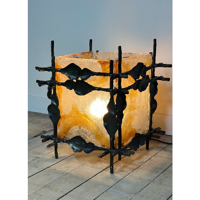 Brutalist table lamp in wrought iron with a stylized foliage motif and four frosted Murano glass panels. Designed by Tom...