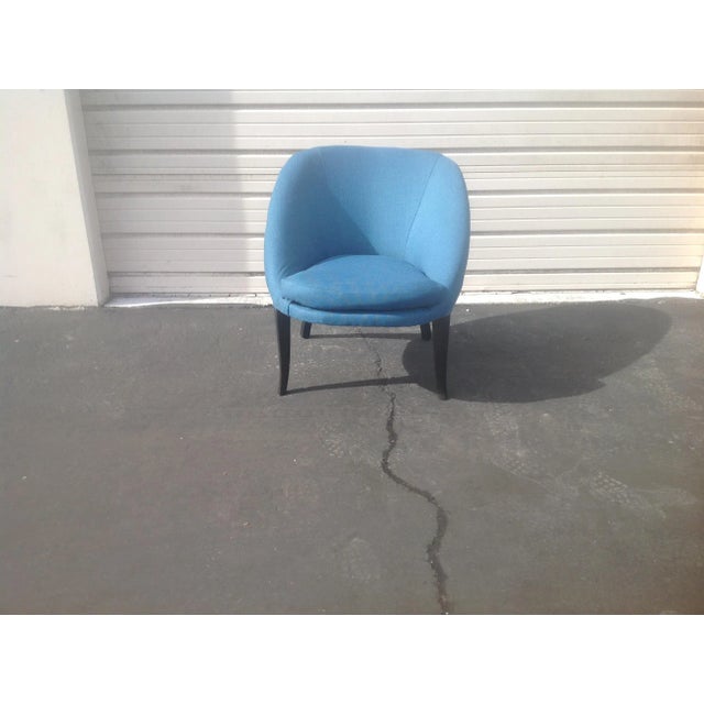 Modern mid century style club chair. Chair was upholstered in a blue chenille. Wood was stained in a matte black finish ....