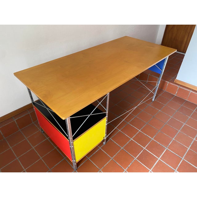 The innovative Eames Desk (1952) includes a file drawer on the right. This original is an authentic, fully licensed...