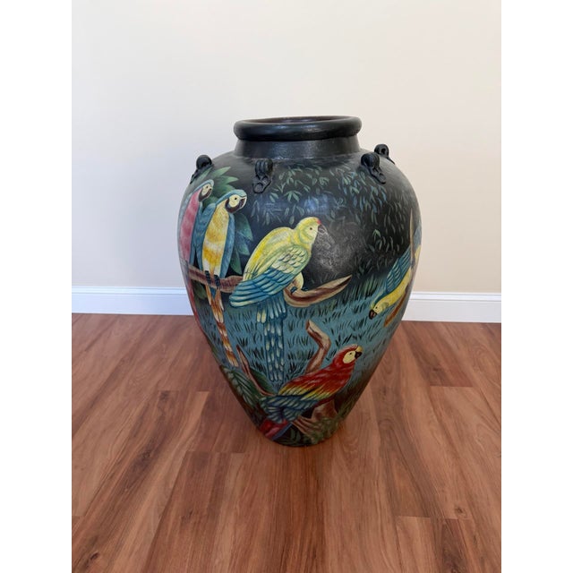 Statement-scale 20th century ceramic urn / floor vase featuring a richly hand-painted tropical bird motif on a deep...