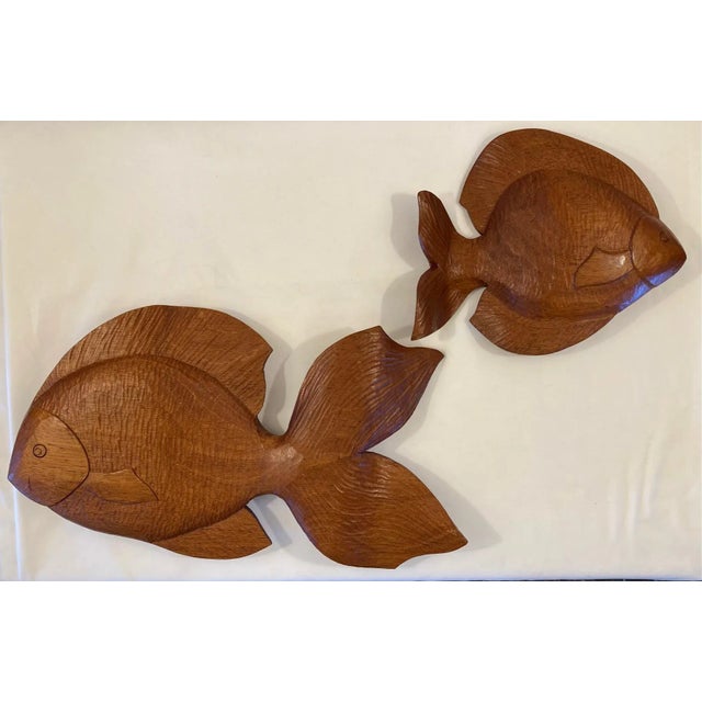 Beautifully hand carved mid century fish. Fish are carved on both sides. Beautiful wood, almost luminescent. Dimensions:...