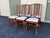 A stunning set of six early 1900s walnut cane back dining chairs. Each chair displays bright, warm walnut tones with woven...