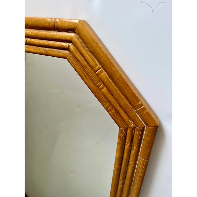Very heavy Vintage Faux Bamboo Wall Mirror. Four rows of carved wood that resembles bamboo in an octogon shape. Very...
