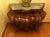A Louis XV style commode of dramatic bombe form, the swelling front and sides veneered in richly figured burl with cross-...