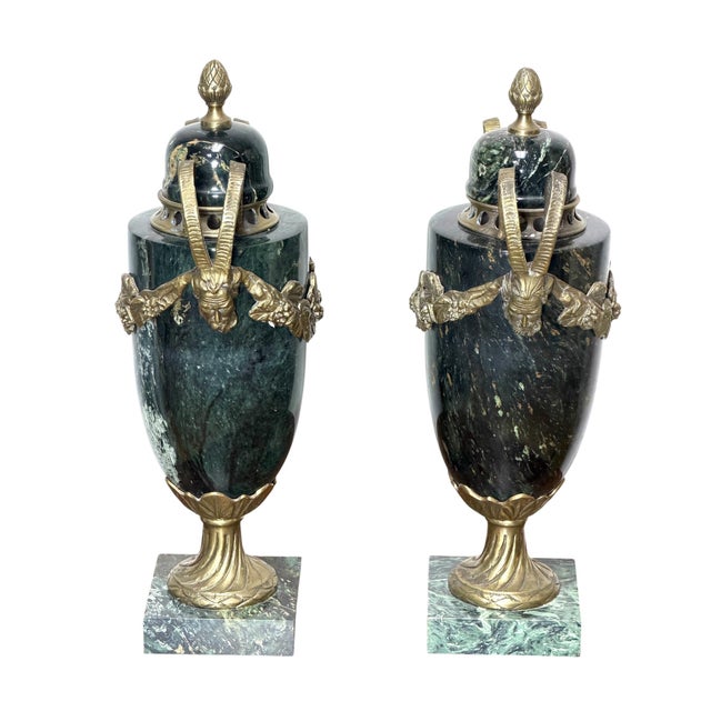 This is pair of Louis XVI style gilt-bronze mounted green marble urns, or cassolettes likely dating from the 19th or early...