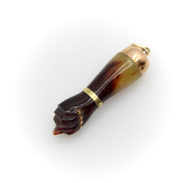 Circa the 1920’s, this celluloid Figa is beautifully carved with 9k gold detailing and a 14k gold bail. The celluloid is a...