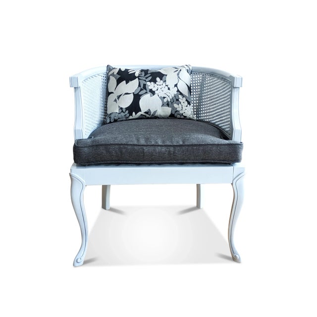 A French provincial cane barrel chair that has been fully restored. We have used a light gray gloss paint for the wood...