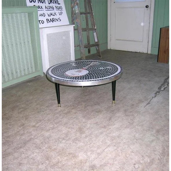 Black and white mosaic tile top low table with musical notes and banjo design. Metal perimeter, black painted wood legs...