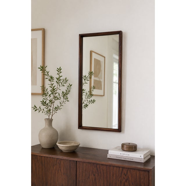 Elegant Danish modern wall mirror by Dyrlund, Denmark, featuring a beautifully crafted rosewood frame with rich grain...