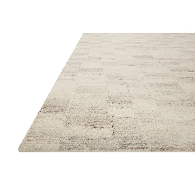 The Rocky Collection area rug by Amber Lewis x Loloi is uniquely hand-tufted with undyed wool to create a subtle and...