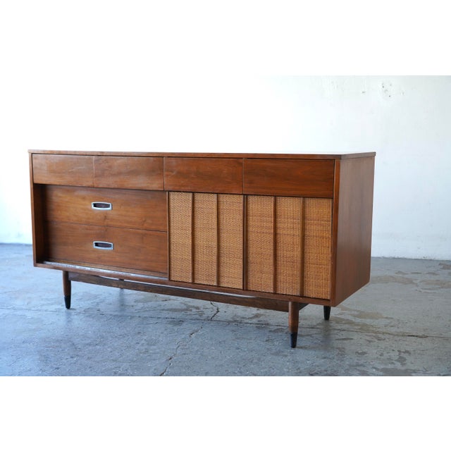 Beautiful vintage walnut dresser by Hooker Furniture, featuring a striking mix of sculpted pull drawers and woven-front...