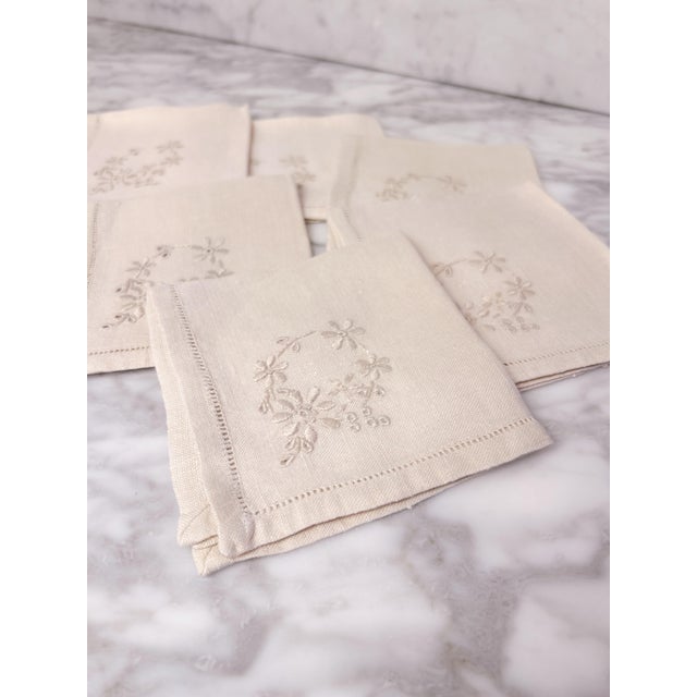 Set of six vintage cream linen tea napkins sourced from Dorset, England. Each napkin is delicately embroidered with...