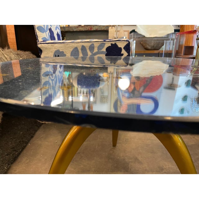 This pretty little table is a wonderful cocktail or side table with a pale blue eglomise mirrored glass top, adorned with...