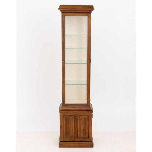 Modern Illuminated Glass-Paneled Fruitwood Vitrine, with linen covered back panel and four glass shelves above a single...