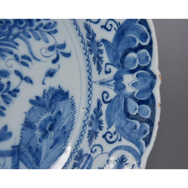 This Dutch Delft charger features a lobed and scalloped rim with a densely painted blue and white surface throughout. The...