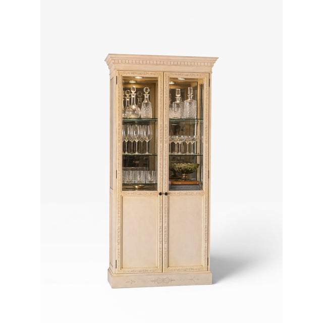 Elegant and refined, this John Widdicomb display cabinet embodies classic neoclassical design with a soft, decorative...