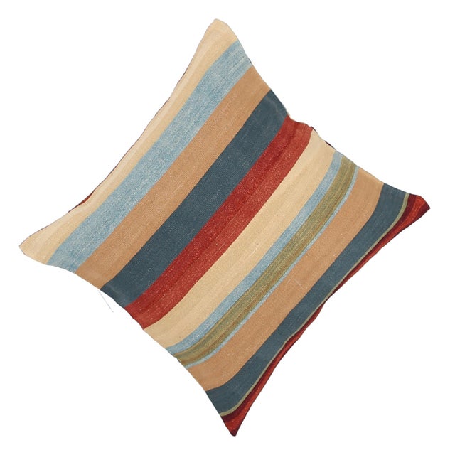 A one-of-a-kind handwoven wool kilim floor pillow featuring a blue-forward multi-stripe with a red center. Fully...