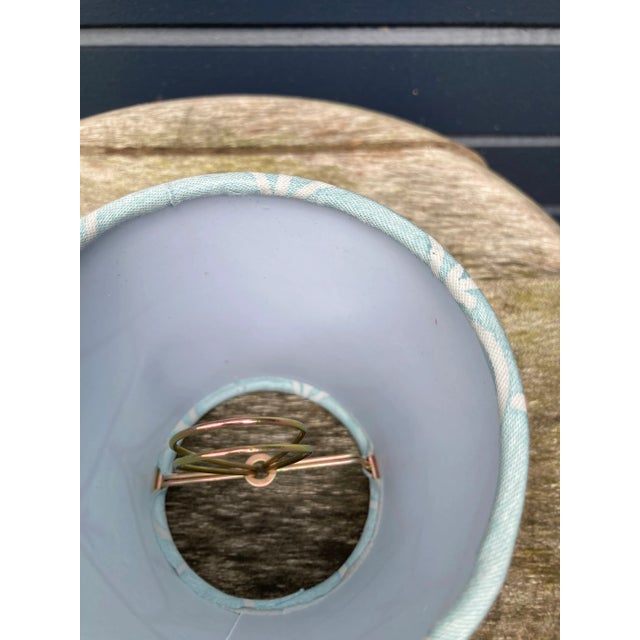 A clip top chandelier shade made from Fortuny’s iconic pattern printed fabric, measurements: top 3” side 4” bottom 4” The...