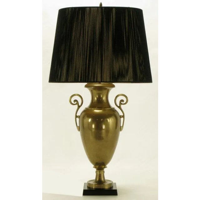 Vintage Chapman Lighting urn form table lamp. Solid brass with open fretwork brass handles, and black marble base. Sold...