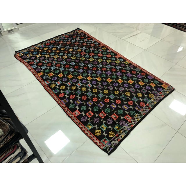 This is a vintage Turkish Anatolian kilim rug from the 1960s. The piece was hand-woven.