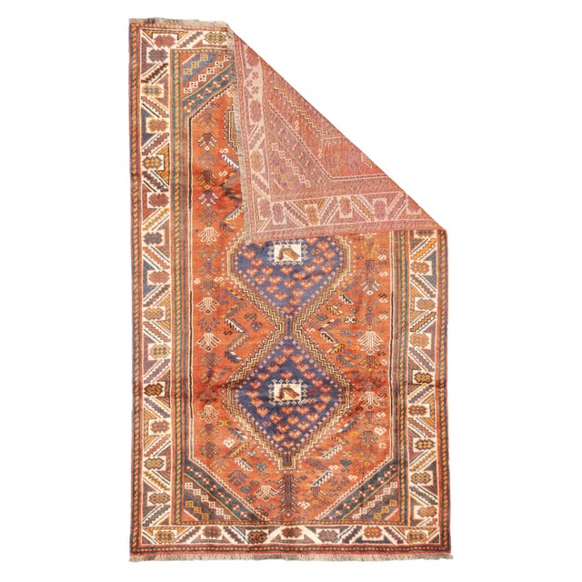 Semi-antique hand-knotted Persian Qashqai rug with three stepped diamond medallions arranged along the central field, each...
