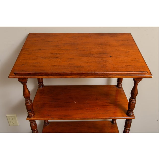 A vintage four-tiered lectern etagere with bobbin turned supports and carved apron. Product Information: Materials:...