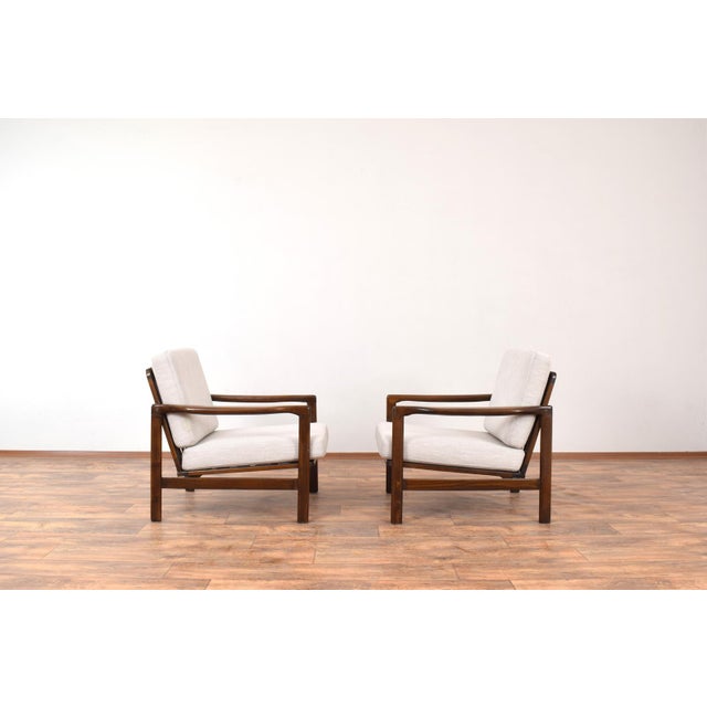 This set of armchairs was designed in the 1960s by Polish designer Zenon Bączyk. The lounge chair frame is made of solid...