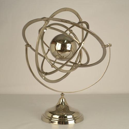 Large chrome globe sculpture, a decorative and educational model featuring a series of rotating planetary rings. The...