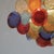 Chandelier with 64 multi-coloured glass disks, hand-made in murano. Chromed metal frame with ten e27 light sockets, new...