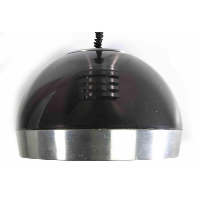 Space Age Chandelier is an original design lamp realized in the 1970s. This vintage lamp is realized in fumé acrylic glass...