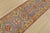 A tribal Caucasian Kazak runner hand-knotted with fine wool on a cotton foundation. This rug features a row of geometric...