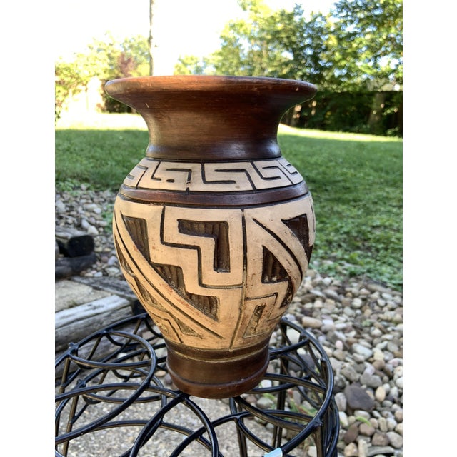 Behold the rustic charm of this vintage, unsigned pottery piece adorned with a captivating brown and white Southwestern...