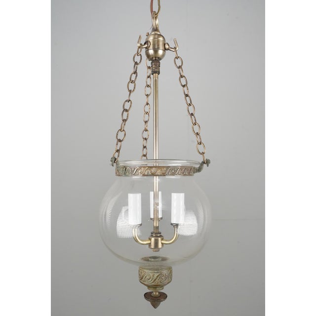 Antique original hand blown clear crystal onion shaped bell jar pendant light with brass hardware. This light requires...