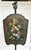 Here is a beautiful antique fireplace screen featuring a hand-painted floral tôle shield mounted on an adjustable wrought...