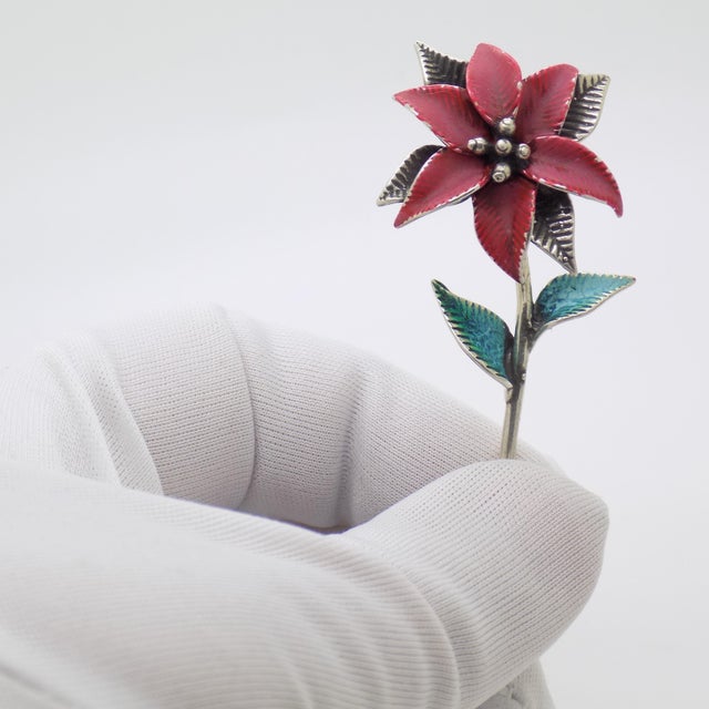 Handcrafted in Italy during the 1980s/1990s, this vintage silver poinsettia miniature brings the festive spirit to life in...