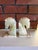 Striking vintage bookends carved from banded onyx, featuring stylized horse head (chess knight) forms. The natural stone...