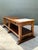 This vintage monumental console table is a striking statement piece, blending rustic craftsmanship with refined material...