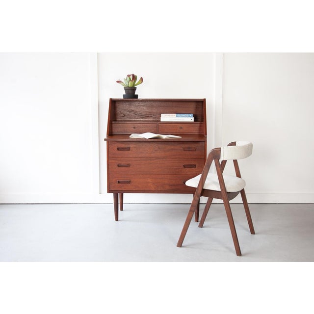 A neat and stylish teak secretary desk, crafted in the 1960s in Denmark with a pull out table top. The upper section...