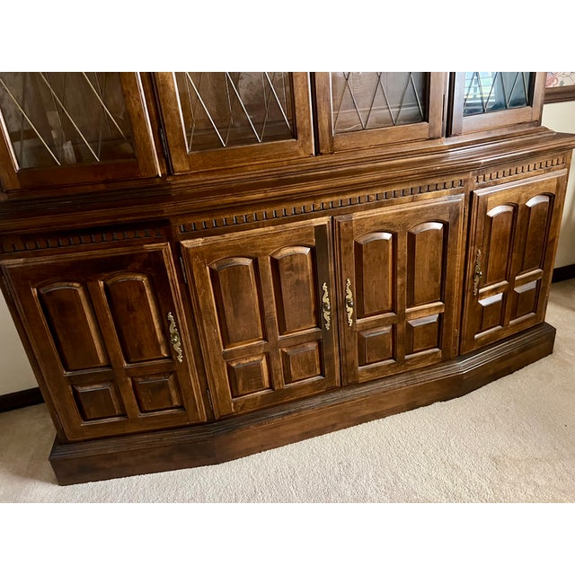 Beautiful solid wood Ethan Allen china cabinet featuring a classic breakfront design with an elegant arched crown and...