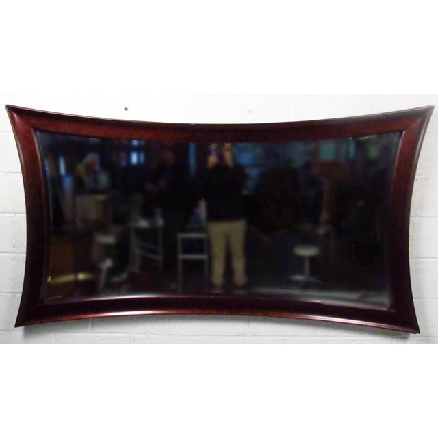 Large contemporary wall mirror featuring wild curved frame with sculpted edges. Please confirm item location NY or NJ with...