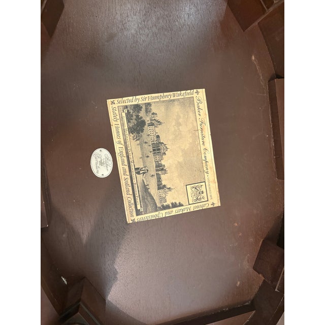 An exceptional oval side table from Baker Furniture's celebrated "Stately Homes of England and Scotland Collection" — the...