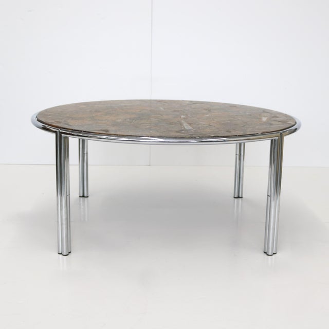 An Italian Modernist coffee cocktail table with fossil marble top from Italy circa 1950. &nbsp;The circular nickel base...