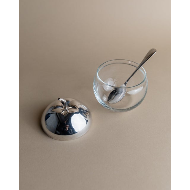 This elegant vintage glass jar in the shape of an apple with a silver-plated lid and spoon dates back to the 1950s and is...